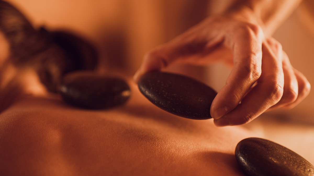 Spa treatment room with warm stones and candles.