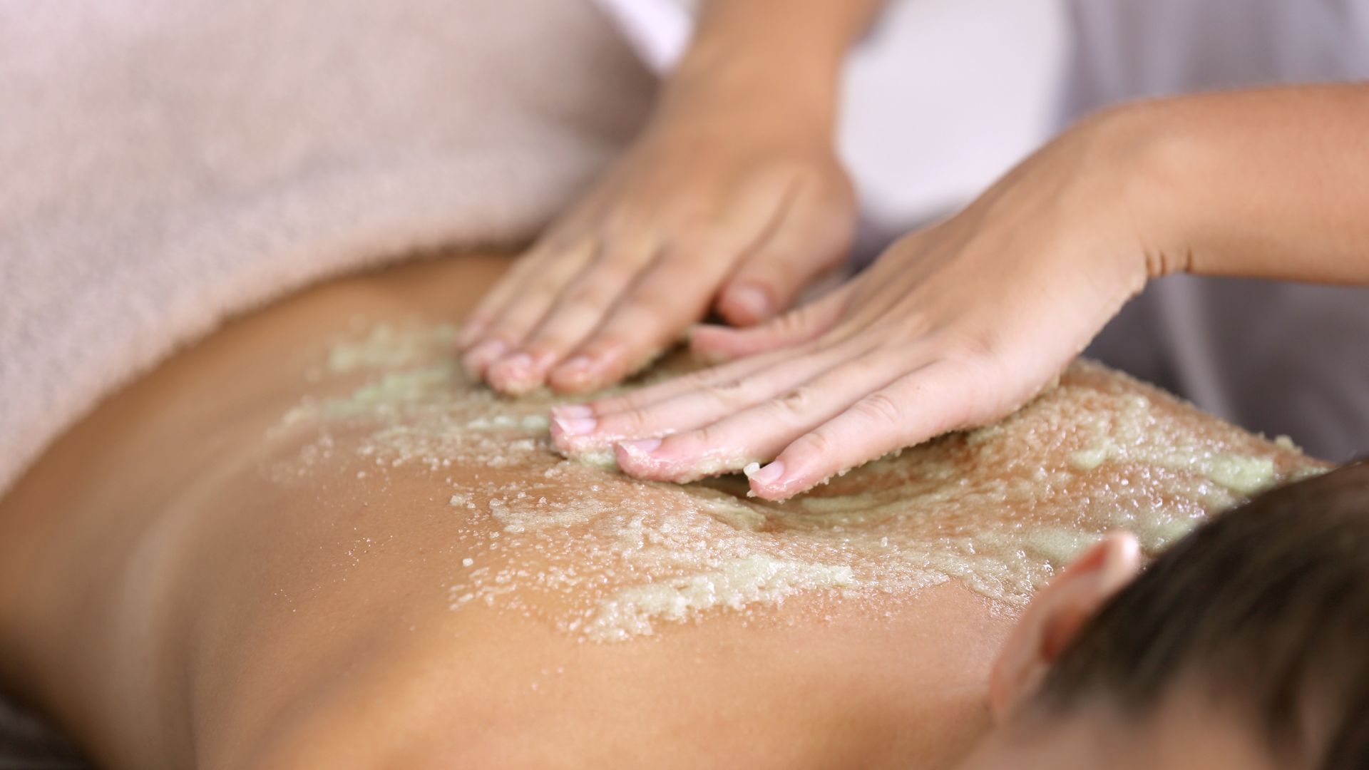 spa treatments guide: Woman receiving a body scrub